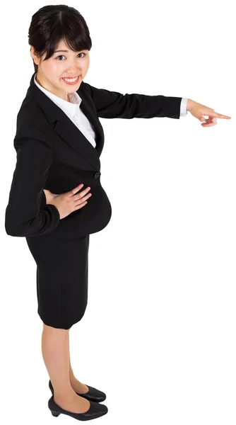 Smiling businesswoman pointing — Stock Photo, Image