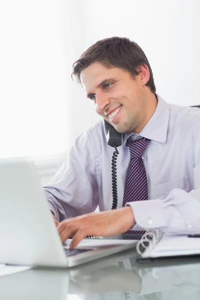 Worried businessman on call at desk — Stock Photo, Image