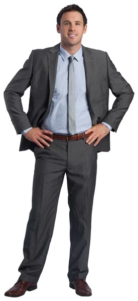 Smiling businessman with hands on hips — Stock Photo, Image