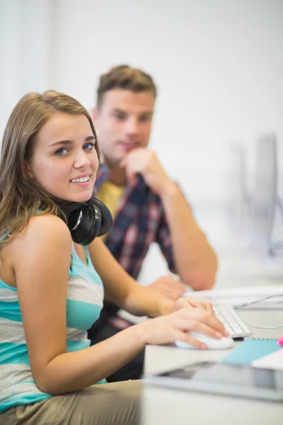 Happy classmates doing an assignment together in the computer room — Stock Photo, Image