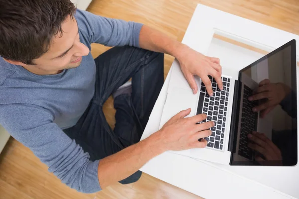 Overhead view of a man using laptop at home — Stock Photo, Image