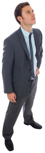 Stern businessman standing with hand on hip — Stock Photo, Image