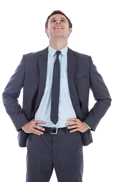 Smiling businessman with hands on hips — Stock Photo, Image