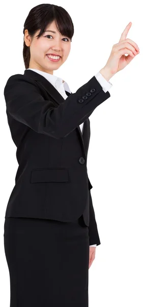 Smiling businesswoman pointing — Stock Photo, Image