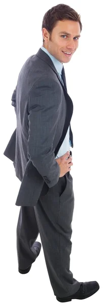 Cheerful businessman standing with hands on hips — Stock Photo, Image