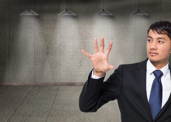 Composite image of unsmiling businessman holding and pointing — Stock Photo, Image