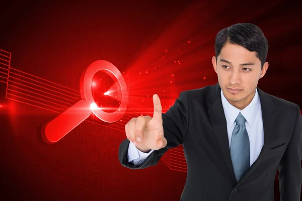 Composite image of unsmiling asian businessman pointing — Stock Photo, Image