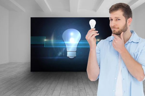 Handsome model holding a bulb — Stock Photo, Image