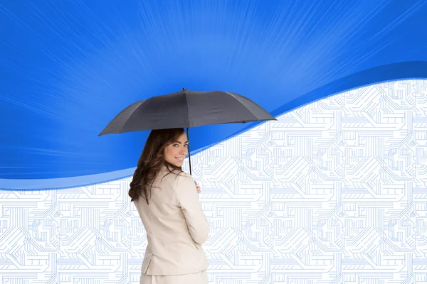 Imagem composta de visão traseira de empresária elegante segurando guarda-chuva — Fotografia de Stock