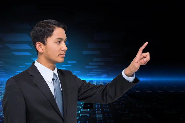 Composite image of stern asian businessman pointing — Stock Photo, Image