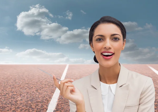 Smiling businesswoman holding a pen — Stock Photo, Image