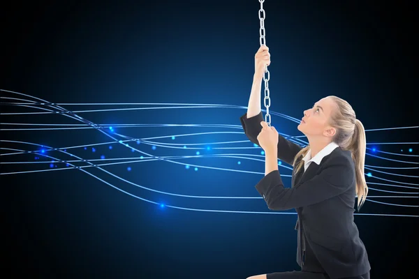 Composite image of businesswoman pulling a chain — Stock Photo, Image