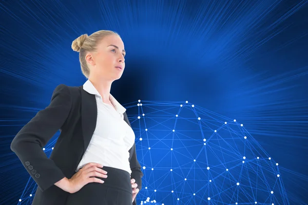 Composite image of businesswoman standing with hands on hips — Stock Photo, Image