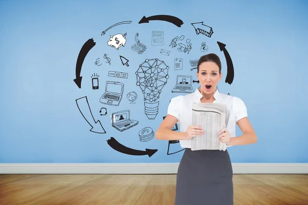 Shocked stylish businesswoman holding newspaper — Stock Photo, Image