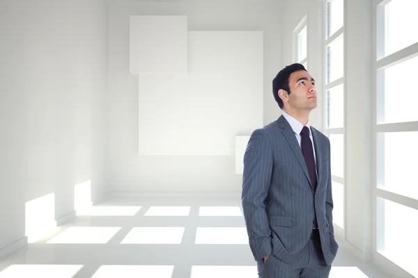 Composite image of unsmiling businessman standing — Stock Photo, Image