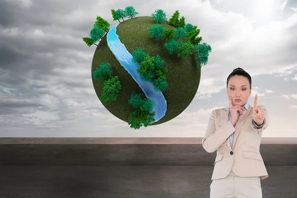 Composite image of thoughtful asian businesswoman pointing — Stock Photo, Image