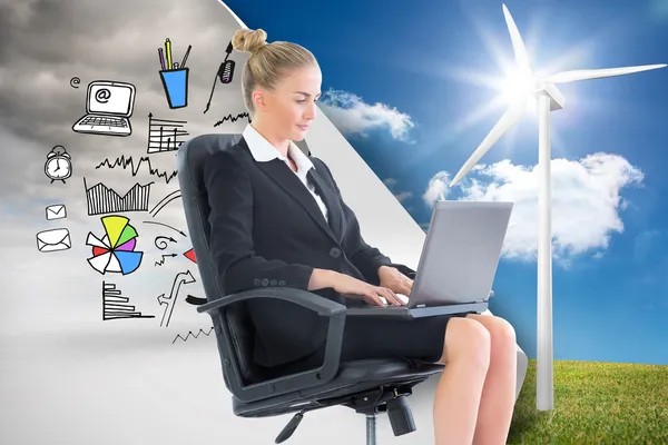 Composite image of businesswoman sitting on swivel chair with laptop — Stock Photo, Image