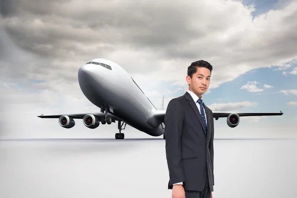 Composite image of frowning businessman looking at camera — Stock Photo, Image