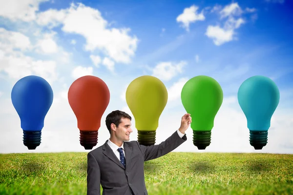 Smiling businessman holding something up in the air — Stock Photo, Image