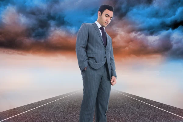 Composite image of unsmiling businessman standing — Stock Photo, Image