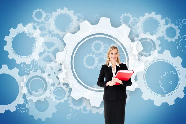 Composite image of businesswoman smiling and holding folders — Stock Photo, Image