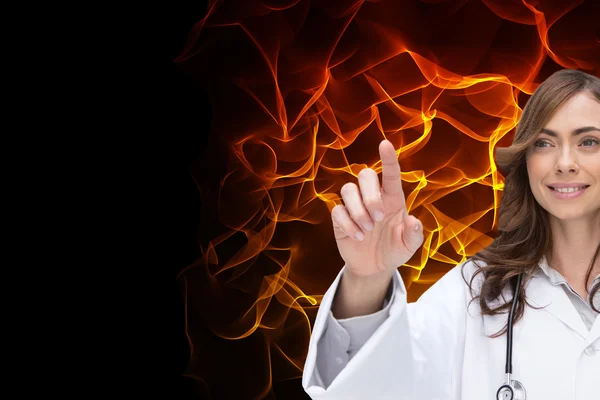 Smiling brunette doctor pointing — Stock Photo, Image