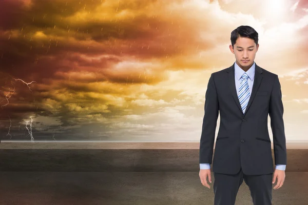 Composite image of serious asian businessman — Stock Photo, Image