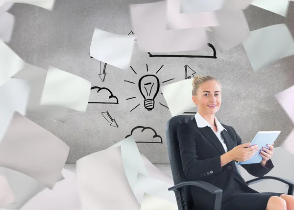 Composite image of businesswoman sitting on swivel chair wiith tablet — Stock Photo, Image