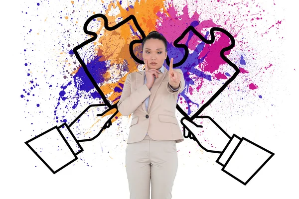 Composite image of thoughtful asian businesswoman pointing — Stock Photo, Image