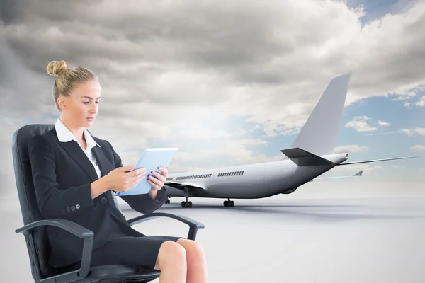 Composite image of businesswoman sitting on swivel chair with tablet — Stock Photo, Image