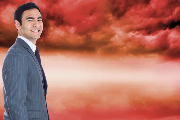 Composite image of smiling businessman standing — Stock Photo, Image