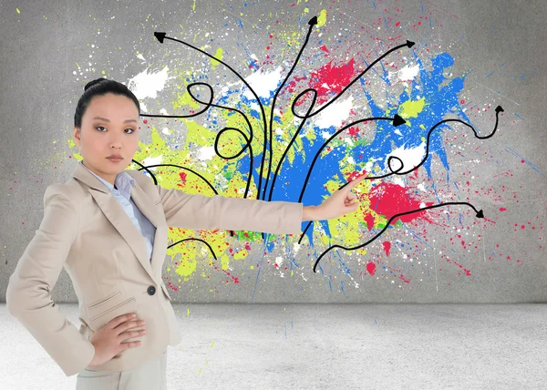 Unsmiling asian businesswoman pointing — Stock Photo, Image