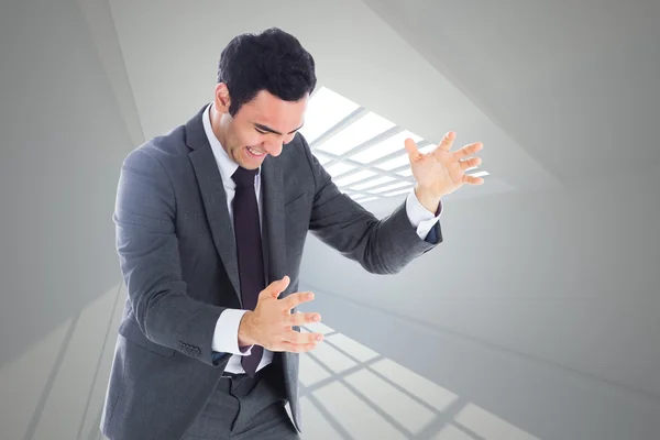 Composite image of stressed businessman catching — Stock Photo, Image