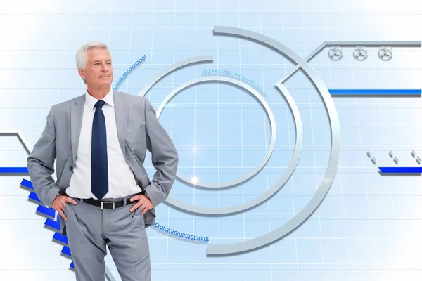 Composite image of man in a suit with his hands on his hips — Stock Photo, Image