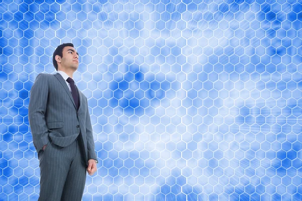 Composite image of unsmiling businessman standing — Stock Photo, Image