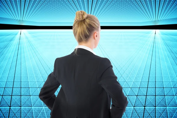Composite image of businesswoman standing with hands on hips — Stock Photo, Image