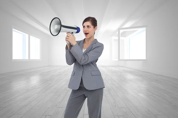 Composite image of businesswoman with loudspeaker — Stock Photo, Image