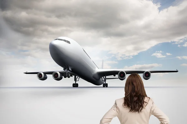 Composite image of businesswoman standing back to camera — Stock Photo, Image