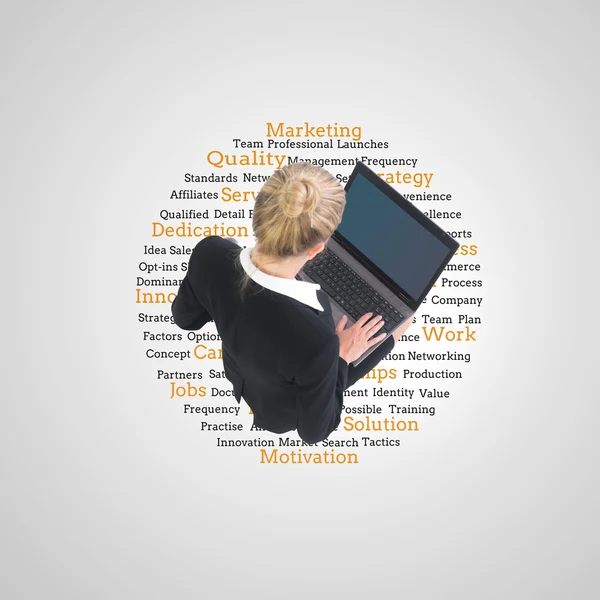 Composite image of businesswoman using laptop — Stock Photo, Image