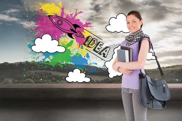 Student holding books and bag — Stock Photo, Image