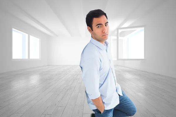 Composite image of unsmiling casual man standing — Stock Photo, Image