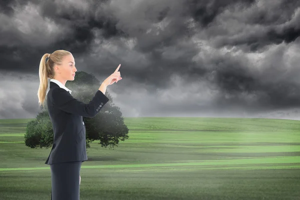 Composite image of businesswoman pointing somewhere — Stock Photo, Image