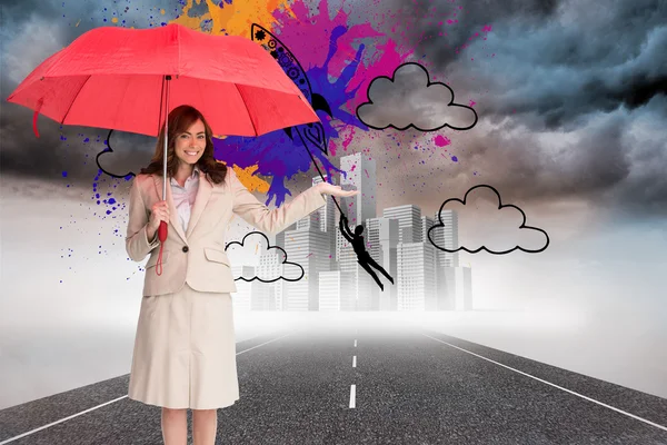 Composite image of happy businesswoman holding umbrella — Stock Photo, Image