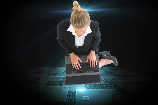 Composite image of businesswoman using laptop — Stock Photo, Image