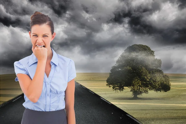 Composite image of furious businesswoman looking at the camera — Stock Photo, Image