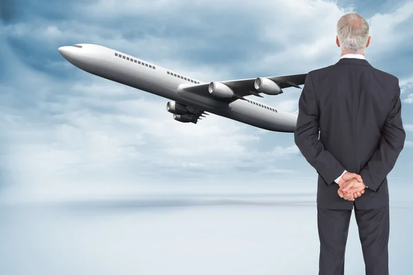 Composite image of rear view of serious businessman posing — Stock Photo, Image