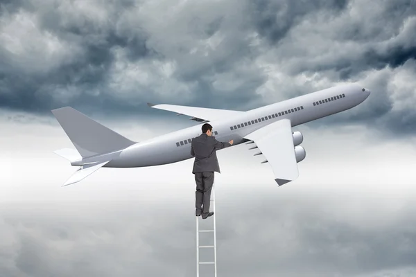 Composite image of businessman standing on ladder — Stock Photo, Image