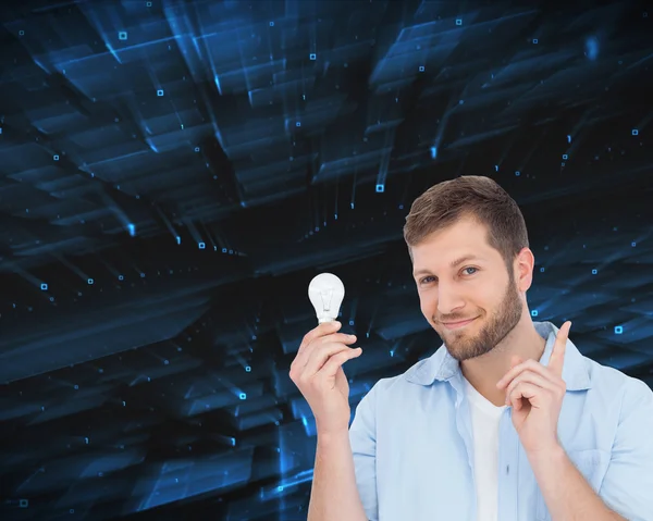 Charming model holding a bulb in right hand — Stock Photo, Image