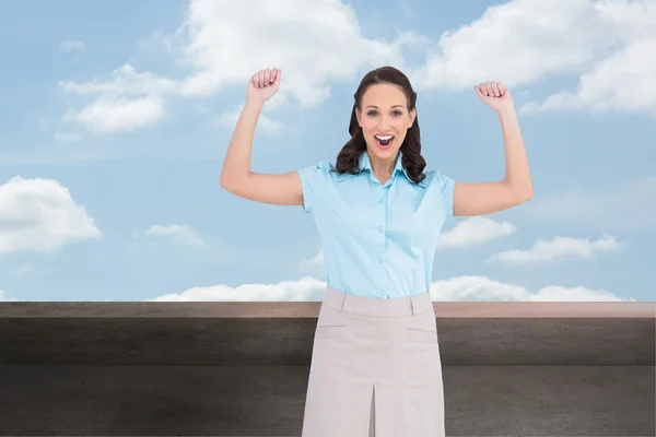 Composite image of victorious stylish businesswoman posing — Stock Photo, Image