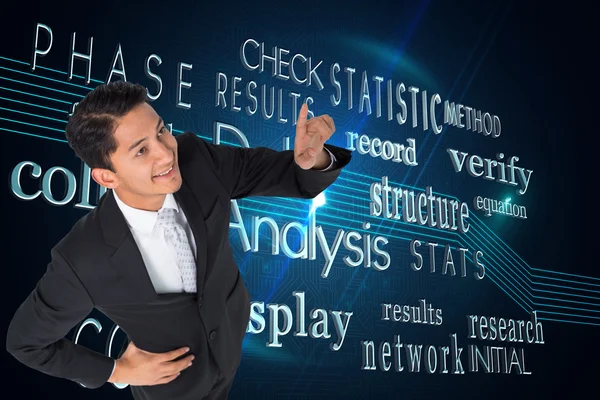 Composite image of smiling asian businessman pointing — Stock Photo, Image